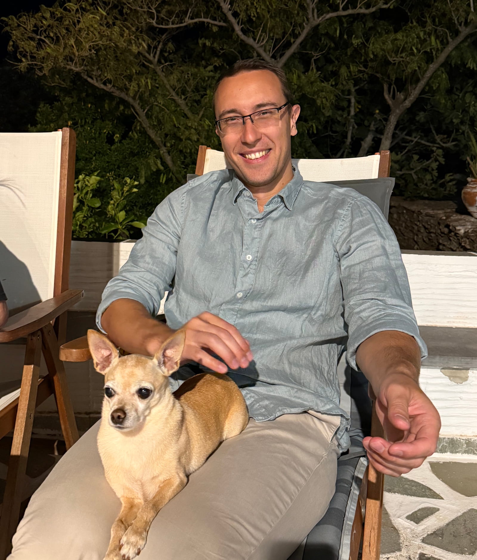 Alexander Kyriakou holding a small dog during summer 2026