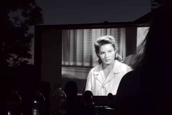 Black and white screening of a movie in an open-air cinema in Athens, Greece taken by Alexander Kyriakou in summer of 2025
